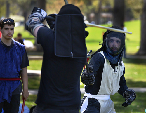 Scott Sommerdorf   |  The Salt Lake Tribune
Zeb Rentz-Bjorge, right, battles with Stefan Tzourakis, as Members of the United Clans Swordsman Association compete in the Long Sword on the east side of Liberty Park, , Saturday, April 12, 2014.