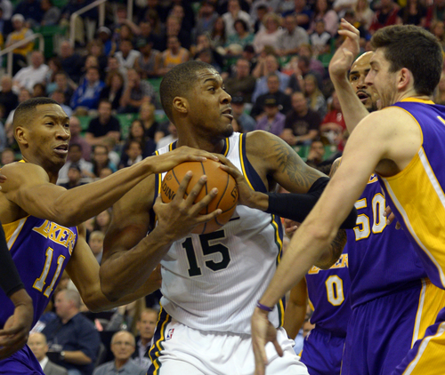 Rick Egan  |  The Salt Lake Tribune

Utah Jazz center Derrick Favors (15) trees to keep control of the ball, as he its triple teamed by Los Angeles Lakers forward Wesley Johnson (11), Los Angeles Lakers center Robert Sacre (50), and Los Angeles Lakers forward Ryan Kelly (4), in NBA action, The Utah Jazz vs. The Los Angeles Lakers, at EnergySolutions Arena, Monday, April 14, 2014