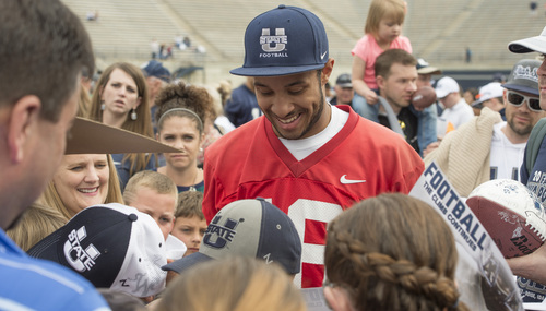 Rick Egan  |  The Salt Lake Tribune

Chuckie Keeton is surrounded by fans as he signs autographs after the final Utah State spring scrimmage, Saturday, April 12, 2014.
