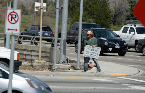 Franciso Kjolseth  |  The Salt Lake Tribune
Joe Ortega, 53, panhandles off the freeway in Sugar House using a sign in what he calls "flagging" as a way to make it on the street day by day. Ortega moved to the Sugar House area from downtown Salt Lake City because of safety concerns. He says he's been sober for three months after being introduced to alcohol at the age of 12.
