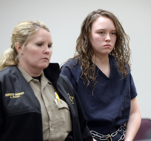 Al Hartmann  |  The Salt Lake Tribune
Meagan Grunwald, a teen charged in connection with a fatal officer shooting in Utah County is escorted by baliff into her preliminary hearing in Judge Darold McDade's courtroom in Provo Wednesday April 16.
