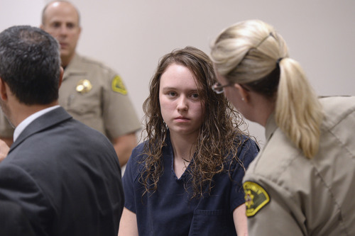 Al Hartmann  |  The Salt Lake Tribune
Meagan Grunwald, a teen charged in connection with a fatal officer shooting in Utah County is escorted by baliffs into her preliminary hearing in Judge Darold McDade's courtroom in Provo Wednesday April 16.