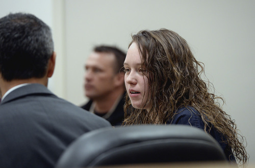 Al Hartmann  |  The Salt Lake Tribune
Meagan Grunwald, a teen charged in connection with fatal officer shooting in Utah County talks to one of her defense lawyers during her preliminary hearing in Judge Darold McDade's courtroom in Provo Wednesday April 16.
