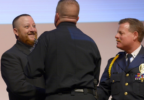 Leah Hogsten  |  The Salt Lake Tribune
Officer Brett Miller with Unified Police Department is congratulated by Deputy Chief Tracy Wyant and honored by the Utah Fraternal Order of Police. "Utah Heroes Night," hosted by the Utah Fraternal Order of Police honored 20 Utah officers for their heroic actions taken last year at Granger High School, Tuesday, April 15, 2014.