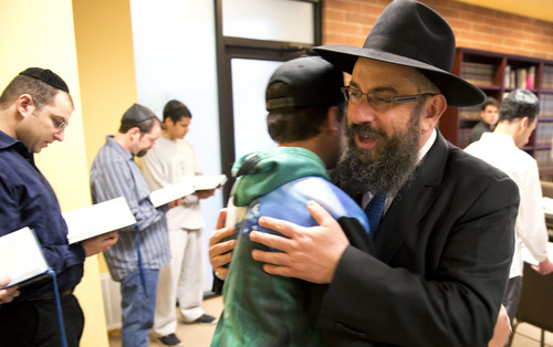Lennie Mahler  |  The Salt Lake Tribune
Rabbi Benny Zippel welcomes Liad Sason to Chabad Lubavitch of Utah and leads members in song before the Passover Seder on Monday, April 14, 2014.