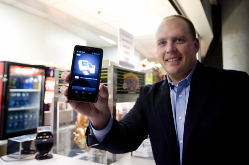 Kim Raff | The Salt Lake Tribune
Dave Roberts, the local Isis City Development Manager, holds a smartphone with the Isis system that allows you to use your smartphone to pay for things at EnergySolutions Arena in Salt Lake City, Utah on November 7, 2012. The system was turned on last week in Salt Lake City and there are over a thousand retailers that use the system.