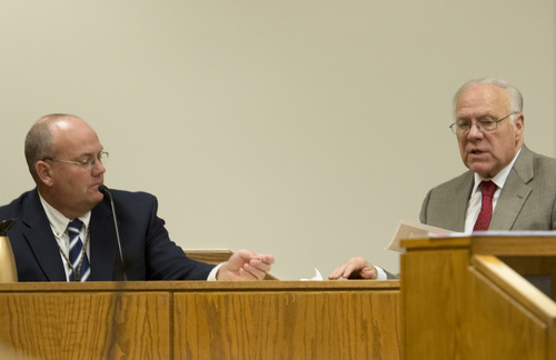 Rick Egan  |  The Salt Lake Tribune

Defense lawyer Dean Zabriskie right, hands a document to Sgt. Scott Finch, Utah County criminal investigator during Meagan Grunwald's preliminary hearing in Judge Darold McDade's courtroom in Provo, Thursday April 17, 2014