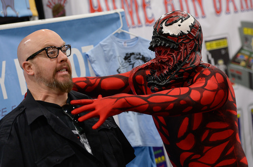 Franciso Kjolseth  |  The Salt Lake Tribune
RobX Musgrave strikes a pose with Lance Monson as "Carnage," at the Salt Palace Convention Center for day two of Salt Lake Comic Con's FanX.