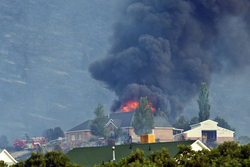 Chris Detrick  |  The Salt Lake Tribune
The Rose Crest Fire burns around Herriman Friday June 29, 2012. As of about 7 p.m. the fire was estimated at 200 acres in size and at zero containment.