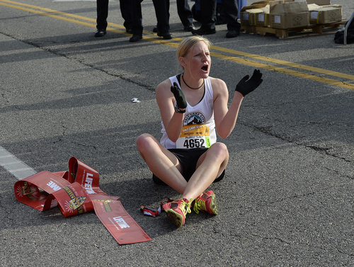 Scott Sommerdorf   |  The Salt Lake Tribune
Allie Moore, the ladies winner of the Salt Lake City half-marathon, cheers other runners after finishing the race, Saturday, April 19, 2014.