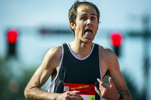 Chris Detrick  |  The Salt Lake Tribune
 Bret Ferrier, 31, of Ogden, crosses the finish line of the Salt Lake City marathon Saturday April 19, 2014. Ferrier finished with a time of 2:32:21.