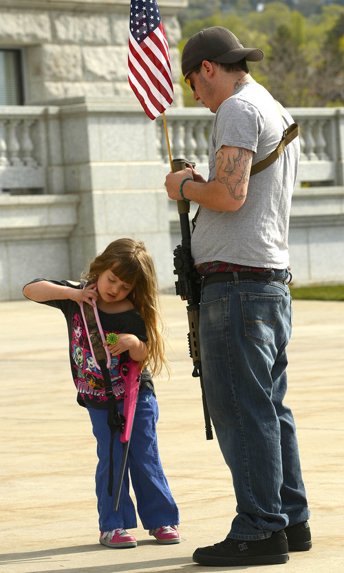 Leah Hogsten  |  The Salt Lake Tribune
Lina Chesley, 4, struggles with the weight of her Savage 22 rifle while attending the The Pro Gun, Pro Constitution, Anti-tyranny Rally with her father Jotham Chesley. Gun rights supporters gathered on the Utah Capitol south steps on the anniversary of Patriots Day, Friday, April 19, 2014.