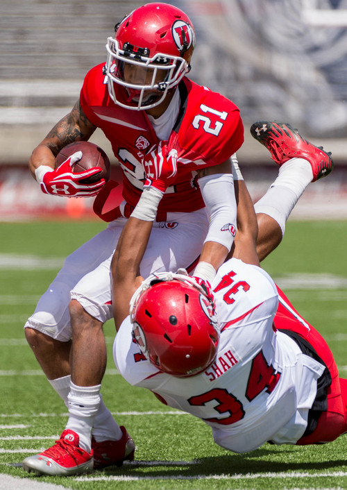 Trent Nelson  |  The Salt Lake Tribune
Utah's Troy McCormick is pulled down by Sharrief Shah during the University of Utah's Red & White football game at Rice-Eccles Stadium in Salt Lake City, Saturday April 19, 2014.