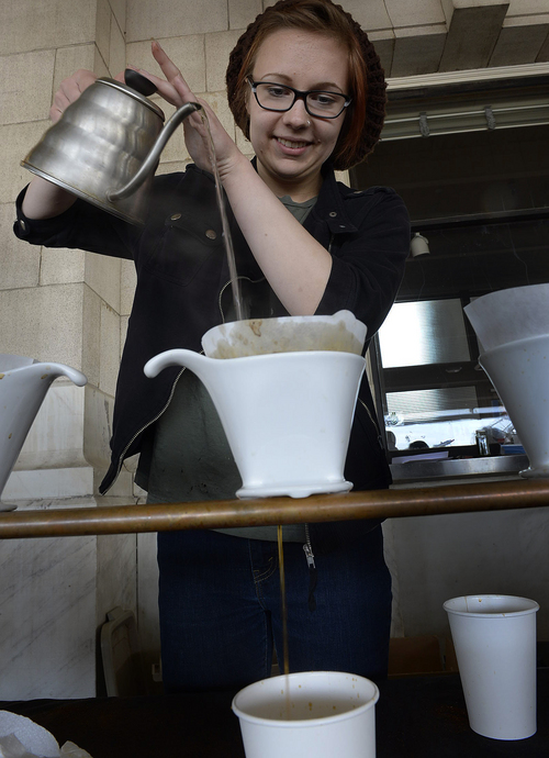 Scott Sommerdorf   |  The Salt Lake Tribune
Gabbi Lemanski pours a Colombian pour-over at the "Charming Beard" coffee booth at the last Downtown Winter Farmers Market of the season, Saturday, April 19, 2014. The market first opened in November and dozens of vendors have been offering local produce, meats, cheeses, baked goods every other Saturday at Rio Grande Depot in downtown Salt Lake City.