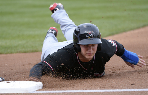 Rick Egan  |  The Salt Lake Tribune

Albuquerque Isotopes outfielder Joc Pederson (3) dives back to first, on a pick-off play, in Pacific Coast League action, The Salt Lake Bees, vs The Albuquerque Isotopes, at Smiths Ballpark,  Monday, April 21, 2014