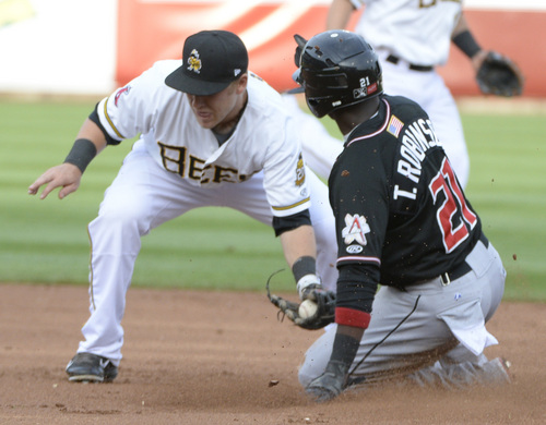 Rick Egan  |  The Salt Lake Tribune

Salt Lake Bees second baseman Taylor Lindsey (8) puts a tag on Albuquerque Isotopes outfielder Trayvon Robinson (21) is tagged out on a stolen base attempt, in Pacific Coast League action, The Salt Lake Bees, vs The Albuquerque Isotopes, at Smiths Ballpark,  Monday, April 21, 2014