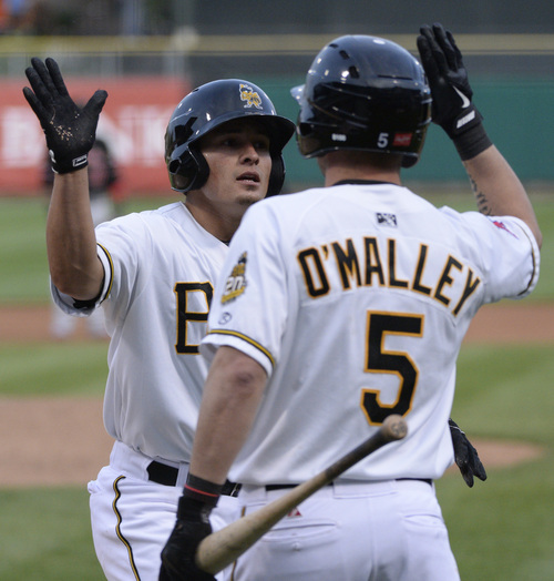 Rick Egan  |  The Salt Lake Tribune

Salt Lake Bees second baseman Tommy Field (12) high-fives Shawn O'Malley (5) after scoring for the Bees, in Pacific Coast League action, The Salt Lake Bees, vs The Albuquerque Isotopes, at Smiths Ballpark,  Monday, April 21, 2014