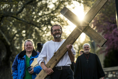 Chris Detrick  |  The Salt Lake Tribune
Alex Bury carries a wooden cross from The Cathedral of the Madeleine during the annual interfaith Good Friday processional Friday April 18, 2014. Since 1983, the Salt Lake Council of Churches has sponsored this annual procession, which is similar to the tradition of the "Via Dolorosa" (Way of Suffering), where pilgrims to Jerusalem follow the path Jesus took to the cross. Rev. Michael J. Imperiale, Pastor of First Presbyterian Church, is at right and Patty Bury is at left.