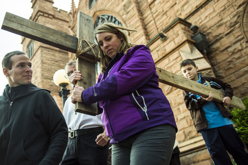 Chris Detrick  |  The Salt Lake Tribune
Mamara Meza and her son Isaac, 9, of Westminster Colo., carries a wooden cross during the annual interfaith Good Friday processional Friday April 18, 2014. Since 1983, the Salt Lake Council of Churches has sponsored this annual procession, which is similar to the tradition of the "Via Dolorosa" (Way of Suffering), where pilgrims to Jerusalem follow the path Jesus took to the cross.
