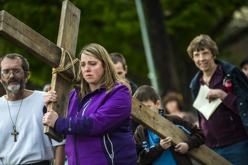 Chris Detrick  |  The Salt Lake Tribune
Mamara Meza and her son Isaac, 9, of Westminster Colo., carries a wooden cross during the annual interfaith Good Friday processional Friday April 18, 2014. Since 1983, the Salt Lake Council of Churches has sponsored this annual procession, which is similar to the tradition of the "Via Dolorosa" (Way of Suffering), where pilgrims to Jerusalem follow the path Jesus took to the cross.