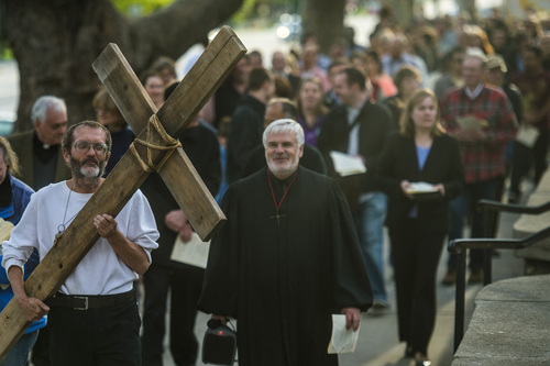 Chris Detrick  |  The Salt Lake Tribune
Alex Bury carries a wooden cross from The Cathedral of the Madeleine during the annual interfaith Good Friday processional Friday April 18, 2014. Since 1983, the Salt Lake Council of Churches has sponsored this annual procession, which is similar to the tradition of the "Via Dolorosa" (Way of Suffering), where pilgrims to Jerusalem follow the path Jesus took to the cross. Rev. Michael J. Imperiale, Pastor of First Presbyterian Church, is at right.