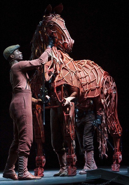 Leah Hogsten | The Salt Lake Tribune
"War Horse" puppeteer Jude Sandy works the head and sounds, Isaac Woofter works the legs, heart and lungs inside and Lute Breuer works the hind legs and tail section to bring the horse puppet to life.