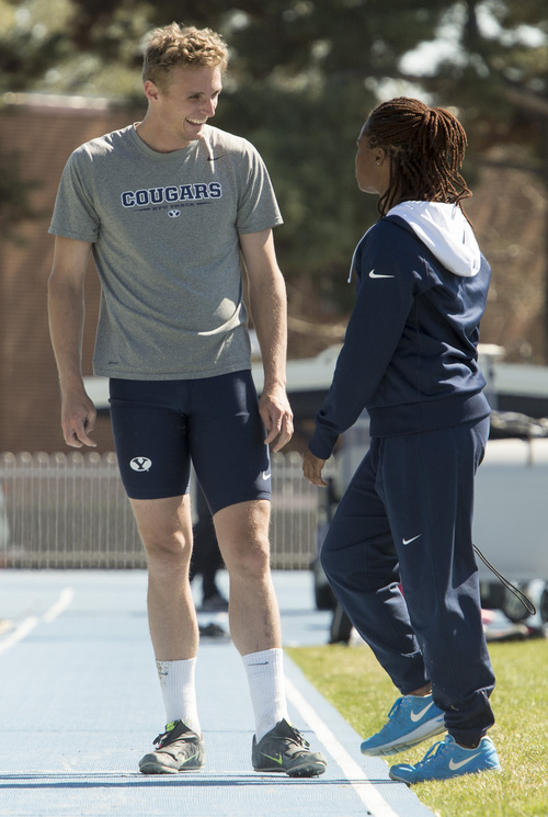 Rick Egan  |  The Salt Lake Tribune

BYU's Chase Dalton  (left) talks with asst. track coach Stephani Perkins (right) during practice at Clarence Robinson Field in Provo, Monday, April 14, 2014.  Dalton has the best score in the Decathlon this season. The senior says the addition of asst. track coach Stephani Perkins has been a big reason for his breakout year.