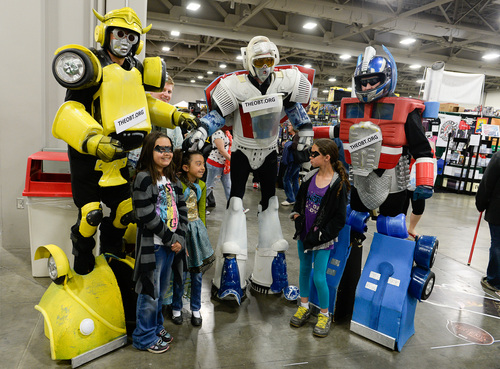 Franciso Kjolseth  |  The Salt Lake Tribune
Zach Reynolds, left, Eric Jensen and Robert Range as "Bumblebee, Star Scream and Optimus Prime," from the Off Broadway Theatre group pose for photos with fans at the Salt Palace Convention Center for day two of Salt Lake Comic Con's FanX.