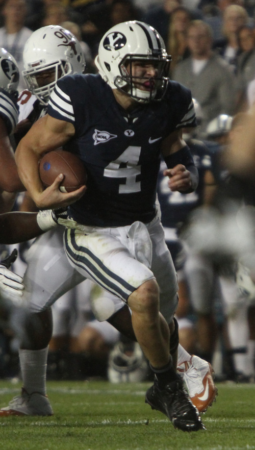 Rick Egan  | The Salt Lake Tribune 

 Brigham Young Cougars quarterback Taysom Hill (4)runs for his second touchdown of the night as BYU played the University of Texas, Lavell Edwards stadium, Saturday, September 7, 2013.