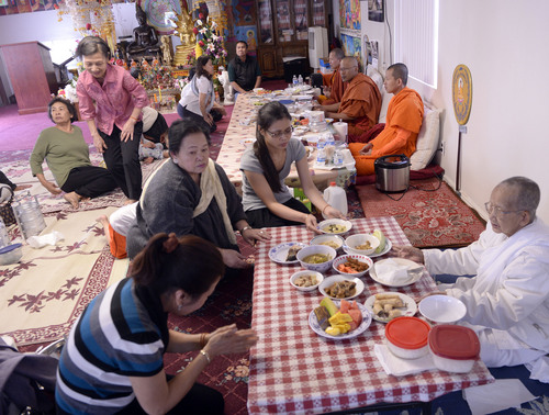 Al Hartmann  |  The Salt Lake Tribune
Members of the Cambodian community honor their Buddhist monks with food they have prepared. They have met in this large converted garage in West Valley City for many years and are raising money to build a bigger temple behind this existing facility.