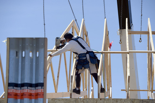 Al Hartmann  |  The Salt Lake Tribune
Construction worker anchors roof joists onto the Cambodian community's new Buddhist temple in West Valley City Thursday April 17.