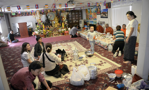 Al Hartmann  |  The Salt Lake Tribune
Members of the Cambodian Buddhist community perform their daily prayers and give their monks food they have prepared. They have met in this large converted garage in West Valley City for many years.  Now they are raising money to construct a much larger building, called Sala Chhan, behind this existing facility.