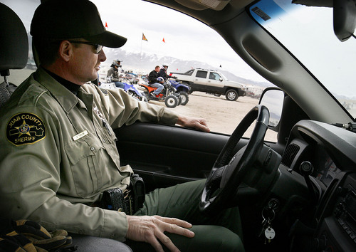 Scott Sommerdorf  |  Salt Lake Tribune
LITTLE SAHARA
Juab County Deputy A. Taylor watches a section of the thousands of riders who come to Little Sahara National Recreation Area, Saturday 4/3/10. Four- and two-wheel enthusiasts, dune buggies and more kick off the spring season with motorized recreation and camping at Little Sahara sand dunes., Saturday 4/3/10.