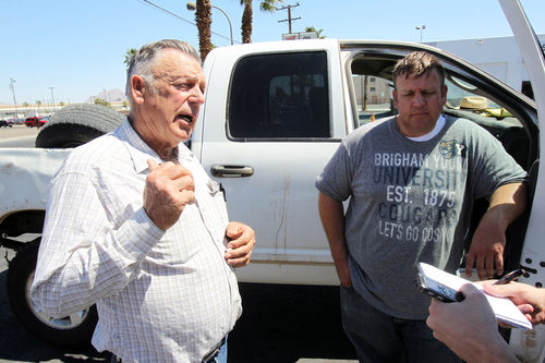 Embattled Bunkerville rancher Cliven Bundy, left, and his son Dave Bundy talk to a reporter on the corner of North Las Vegas Boulevard and East Stewart Avenue in downtown Las Vegas Monday, April 7, 2014. The 37-year-old Dave Bundy was taken into custody by federal agents on Sunday afternoon along state Route 170 near Mesquite. He was released Monday after being issued citations for failing to disperse and resisting arrest. The Bureau of Land Management has begun to round up what they call "trespass cattle" that rancher Cliven Bundy has been grazing in the Gold Butte area 80 miles northeast of Las Vegas.(AP Photo/Las Vegas Review-Journal, K.M. Cannon)