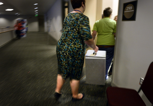 Scott Sommerdorf   |  The Salt Lake Tribune
A ballot box is whisked away to be counted during a break at the Utah Democratic Convention, Saturday, April 26, 2014.