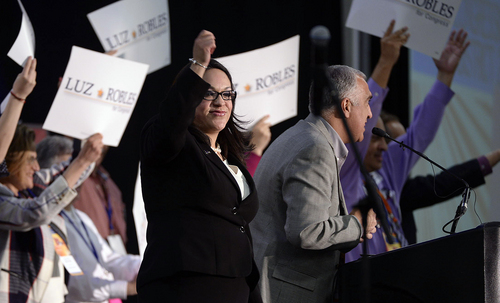 Scott Sommerdorf   |  The Salt Lake Tribune
Luz Robles, candidate for Congress in Utah's 2nd Congressional District, takes the stage at the Utah Democratic Convention after being introduced by Salt Lake District Attorney Sim Gill, right, Saturday, April 26, 2014.