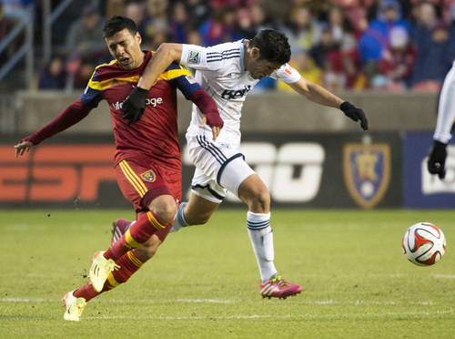 Rick Egan  |  The Salt Lake Tribune

Vancouver FC midfielder Matias Laba (15) grabs Javier Morales (11), as he goes for the ball, in MLS action, Real Salt Lake vs. The Vancouver Whitecaps, Wednesday, April 23, 2014
