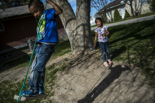 Chris Detrick  |  The Salt Lake Tribune
Luis Granda, 8, and Katy Granda, 6, play on a swing at their home in Garland Wednesday April 16, 2014. Part of the family has been ordered to be deported to El Salvador.