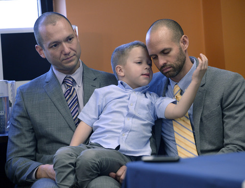 Al Hartmann  |  The Salt Lake Tribune
Plaintiffs Matthew Barraza, left, and Tony Milner, who are legally married, listen to the announcement with their son Jesse, regarding the ACLU of Utah filing a lawsuit Tuesday Jan. 21, 2014, in Salt Lake City over Utah's refusal to recognize valid same-sex marriages that occurred before the U.S. Supreme Court issued a stay.