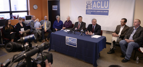 Al Hartmann  |  The Salt Lake Tribune
 John Mejia, legal director, ACLU of Utah, center, and Erik Strindberg, lawyer for plaintiffs, center right, announce filing of a lawsuit Tuesday Jan. 21, 2014, in Salt Lake City over Utah's refusal to recognize valid same-sex marriages that occurred before the U.S. Supreme Court issued a stay. Four couples in the lawsuit are behind them left and right.