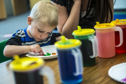 Chris Detrick  |  The Salt Lake Tribune
Henry David Politis, 2, finger paints during 'Literacy Night' at Kauri Sue Hamilton School Child Development Center Tuesday April 29, 2014. Families of special needs children who are part of the Early Intervention Program, age birth to 3-years-old, received a copy of the 'Napping House' by Audrey Wood and participated in activities throughout the evening  highlighted parts of the book.