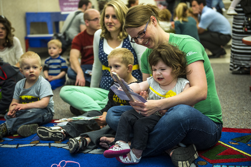 Chris Detrick  |  The Salt Lake Tribune
Kristin Walker and her daughter Emma, 20 months, read along during 'Literacy Night' at Kauri Sue Hamilton School Child Development Center Tuesday April 29, 2014. Families of special needs children who are part of the Early Intervention Program, age birth to 3-years-old, received a copy of the 'Napping House' by Audrey Wood and participated in activities throughout the evening  highlighted parts of the book.