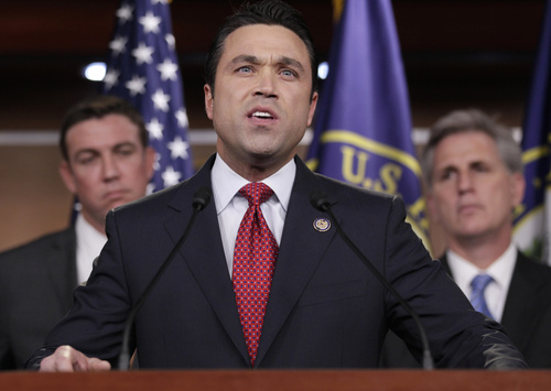 FILE - In this April 7, 2011, file photo, Rep. Michael Grimm, R-N.Y., center, accompanied by Rep. Duncan Hunter, R-Calif., left, House Majority Whip Kevin McCarthy of Calif., speaks during a news conference on Capitol Hill in Washington. Grimm's attorney stated on Friday, April 25, 2014, that federal prosecutors in New York plan on filing criminal charges against the lawmaker. Lawyer William McGinley said Grimm is innocent and called the federal probe into the former FBI agent-turned-politician "a politically driven vendetta." (AP Photo/Carolyn Kaster, File)