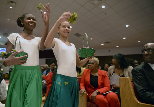 Al Hartmann  |  The Salt Lake Tribune
Members of the Pearls of Praise Dance Group drops flower petals in the aisle in processional at Calvary Baptist Church to celebrate Pastor France Davis's 40th anniversary as pastor in a special celebration Sunday April 27 in Salt Lake City.