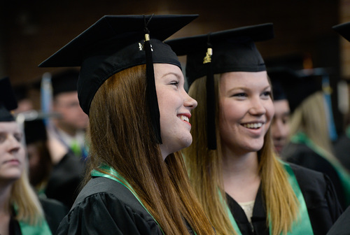 Franciso Kjolseth  |  The Salt Lake Tribune
Utah Valley University twin sister graduates Haley, left, and Makenzie Beach attend commencement ceremonies at the UCCU Center in Orem on Thursday, May 1.