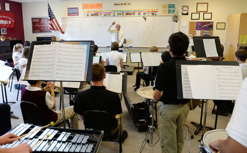 Steve Griffin  |  The Salt Lake Tribune
Don Abernathy conducts the concert band during class at Monticello Academy, a charter school in Salt Lake City on Wednesday, April 30, 2014.  A new report says Utah's charter schools receive less state funding per pupil than traditional public schools.