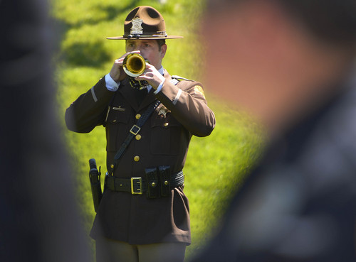 Leah Hogsten  |  The Salt Lake Tribune
UHP officer Jared Clanton plays TAPS. Draper Police Sgt. Derek Johnson and Utah County Sheriff's Sgt. Cory Wride's names  were added to the Utah Fallen Officer Memorial in a ceremony, Thursday, May 1, 2014 on the State Capitol grounds.