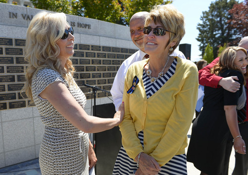 Leah Hogsten  |  The Salt Lake Tribune
l-r Nanette Wride, wife of Utah County Sheriff's Sgt. Cory Wride talks with parents of Draper Police Sgt. Derek Johnson, Randy and Laura Johnson after the ceremony.  Johnson and Wride's names  were added to the Utah Fallen Officer Memorial in a ceremony, Thursday, May 1, 2014 on the State Capitol grounds.