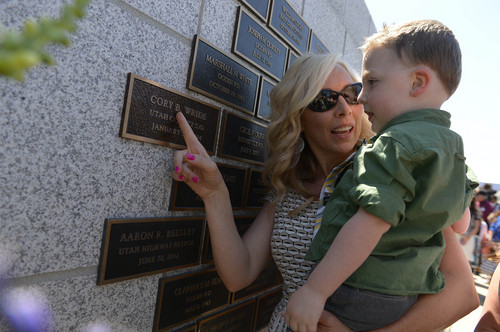 Leah Hogsten  |  The Salt Lake Tribune
l-r Sheriffís Sgt. Cory Wride's wife Nanette holds her grandson Blake Wride, 4, and says "that's Papa" while pointing out Wride's nameplate.  Draper Police Sgt. Derek Johnson and Utah County Sheriffís Sgt. Cory Wride's names  were added to the Utah Fallen Officer Memorial in a ceremony, Thursday, May 1, 2014 on the State Capitol grounds.