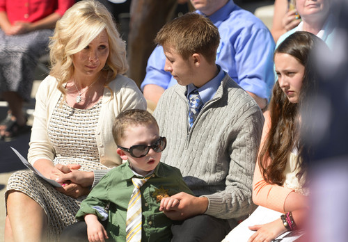 Leah Hogsten  |  The Salt Lake Tribune
l-r Sheriff's Sgt. Cory Wride's wife Nanette looks to son Tyesun at Wride's service.  Draper Police Sgt. Derek Johnson and Utah County Sheriff's Sgt. Cory Wride's names  were added to the Utah Fallen Officer Memorial in a ceremony, Thursday, May 1, 2014 on the State Capitol grounds.